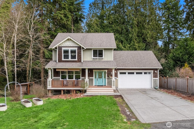 view of front of property with roof with shingles, covered porch, an attached garage, driveway, and a front lawn