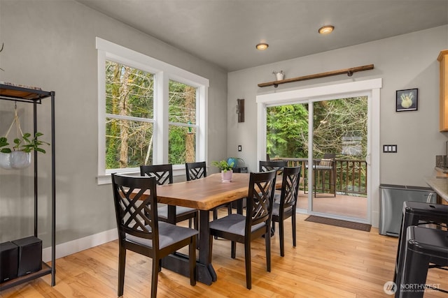 dining room with recessed lighting, light wood-style flooring, and baseboards