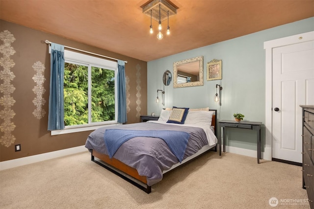 carpeted bedroom featuring baseboards