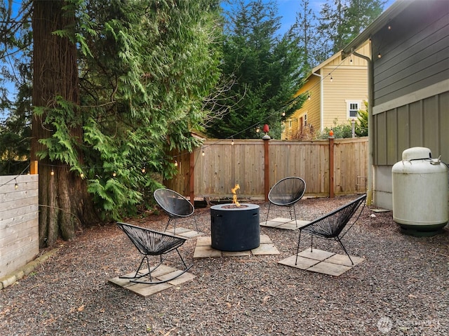 view of patio with an outdoor fire pit and a fenced backyard