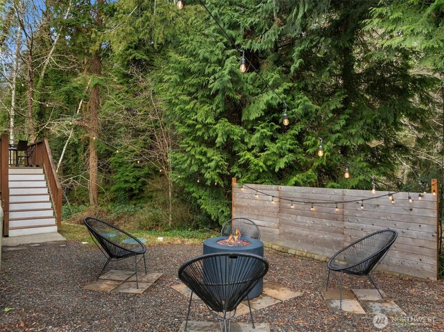 view of yard with an outdoor fire pit and stairway