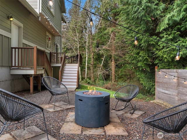 view of patio with a deck, an outdoor fire pit, and stairway