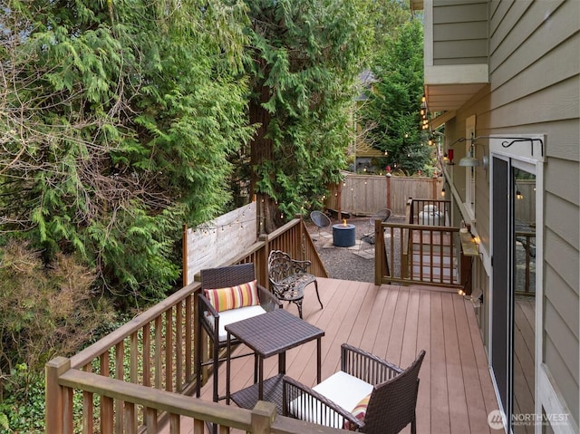 wooden terrace featuring fence