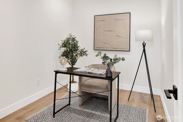 office space with light wood-style flooring and baseboards