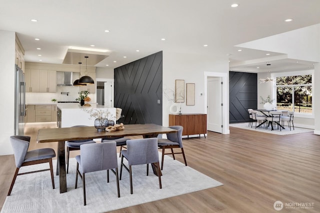 dining room with light wood finished floors and recessed lighting