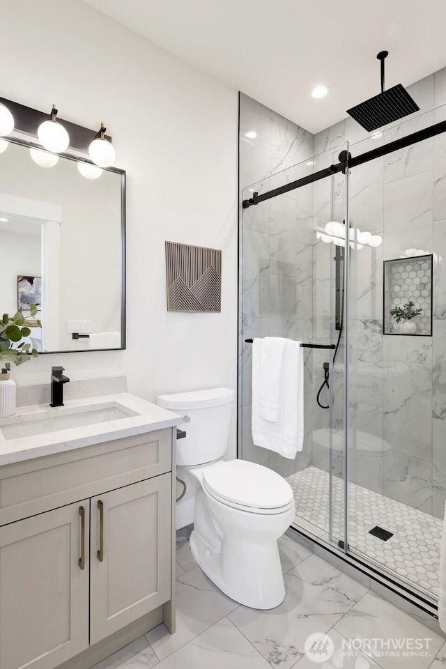 bathroom with a marble finish shower, toilet, marble finish floor, vanity, and recessed lighting