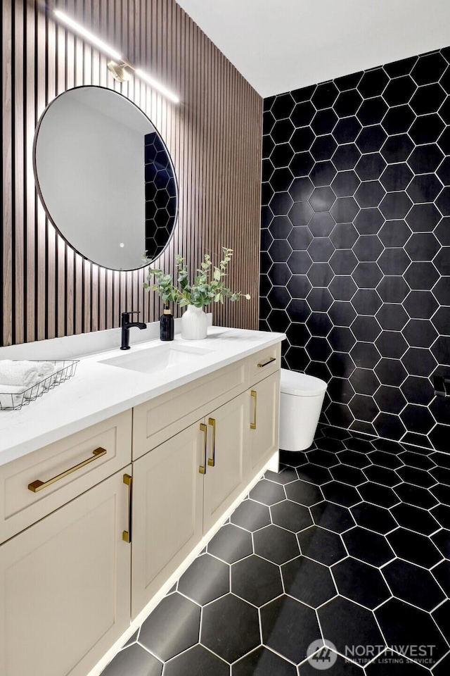 bathroom featuring toilet, tile patterned flooring, and vanity