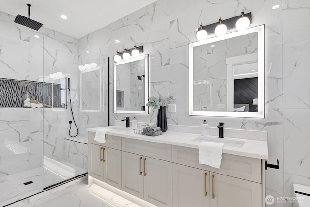 full bath with stone wall, double vanity, a sink, and a marble finish shower