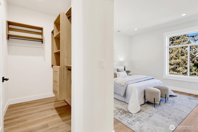 bedroom with light wood finished floors, baseboards, and recessed lighting