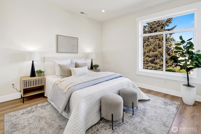 bedroom featuring recessed lighting, wood finished floors, visible vents, and baseboards