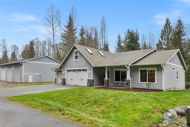 craftsman-style home with a garage, roof with shingles, and a front yard