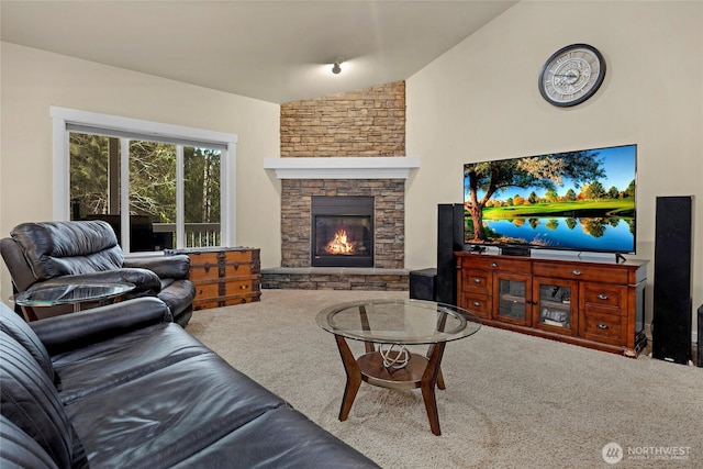 living area featuring a fireplace, lofted ceiling, and carpet floors