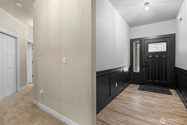 foyer entrance featuring light wood-type flooring and baseboards