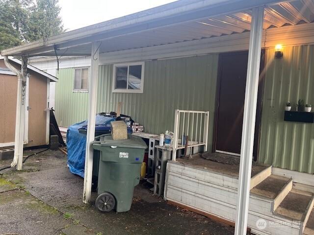 exterior space with a carport and an outbuilding