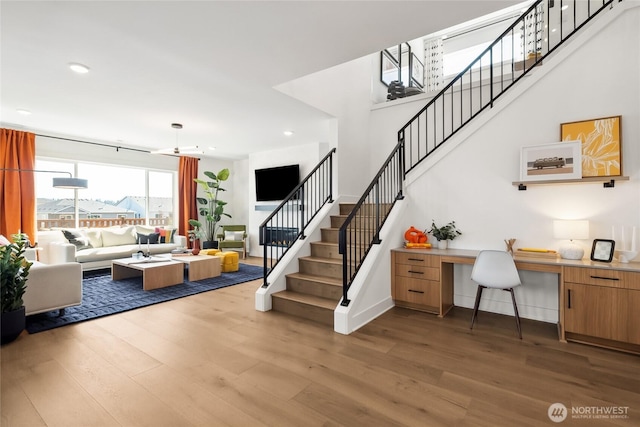 interior space with recessed lighting, built in desk, baseboards, and wood finished floors