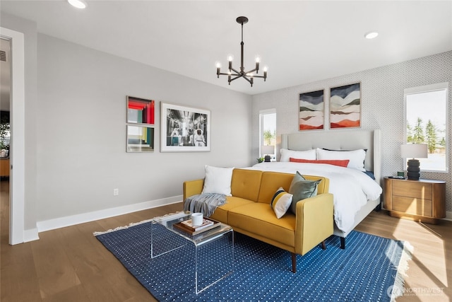 bedroom featuring baseboards, a chandelier, wood finished floors, and recessed lighting