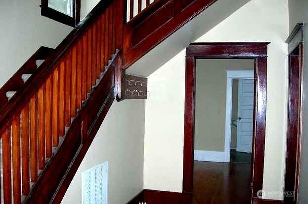 interior space featuring wood finished floors, visible vents, and baseboards