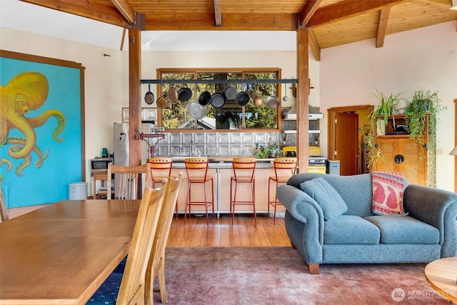 living room with wet bar, hardwood / wood-style flooring, vaulted ceiling with beams, and wood ceiling