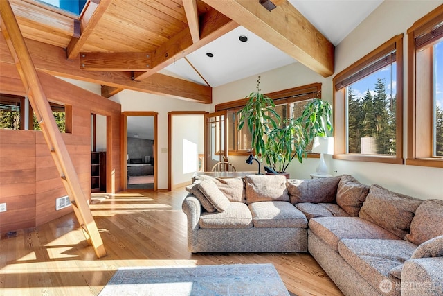 living room with vaulted ceiling with skylight and wood finished floors