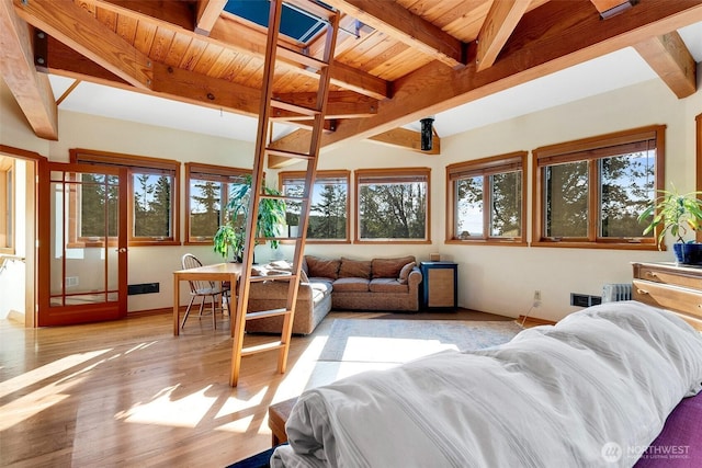 living room with beamed ceiling, wood ceiling, baseboards, and wood finished floors