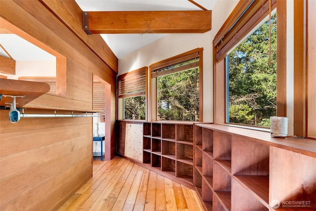 interior space with hardwood / wood-style floors, beam ceiling, and a wealth of natural light