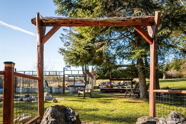 view of home's community featuring a lawn and fence