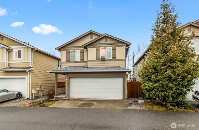 view of front of home with an attached garage, driveway, a shingled roof, and fence