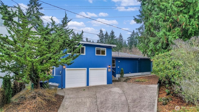 view of front of house with a garage and concrete driveway