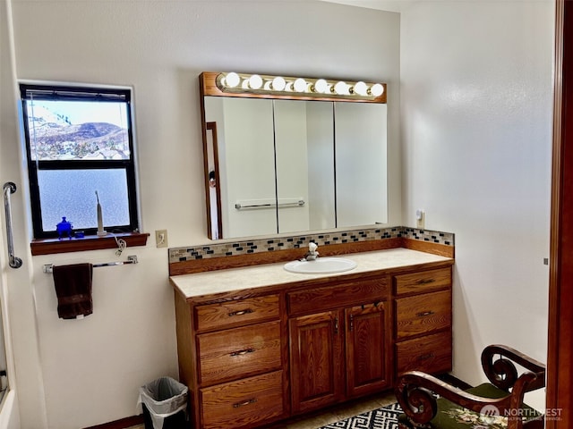 bathroom with tasteful backsplash and vanity