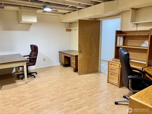 office featuring light wood finished floors, visible vents, and baseboards