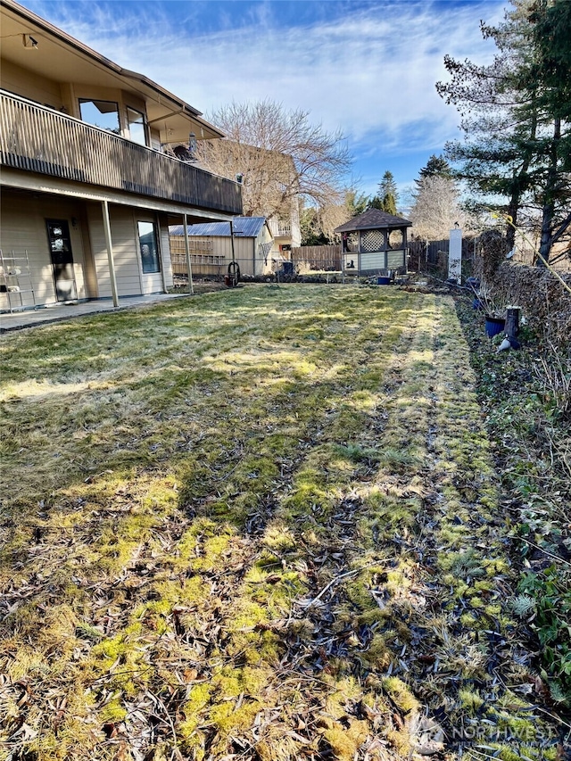 view of yard with fence and a gazebo