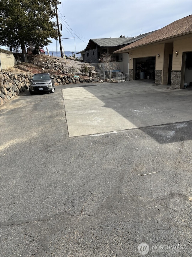 view of car parking featuring a garage and driveway