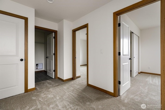 corridor with carpet flooring and baseboards