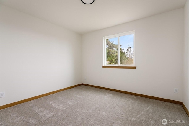 unfurnished room featuring baseboards and carpet flooring