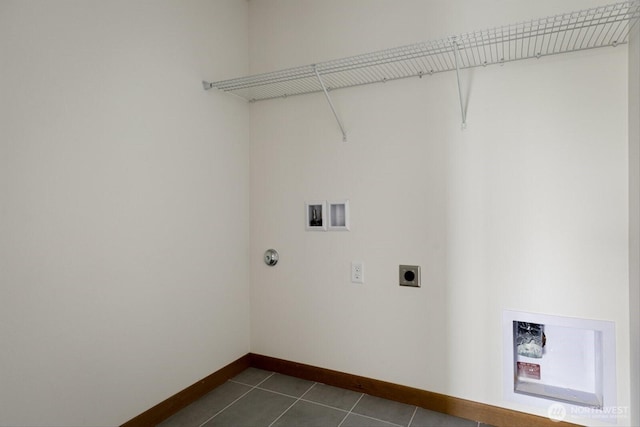 laundry room featuring hookup for a washing machine, hookup for an electric dryer, laundry area, dark tile patterned floors, and baseboards