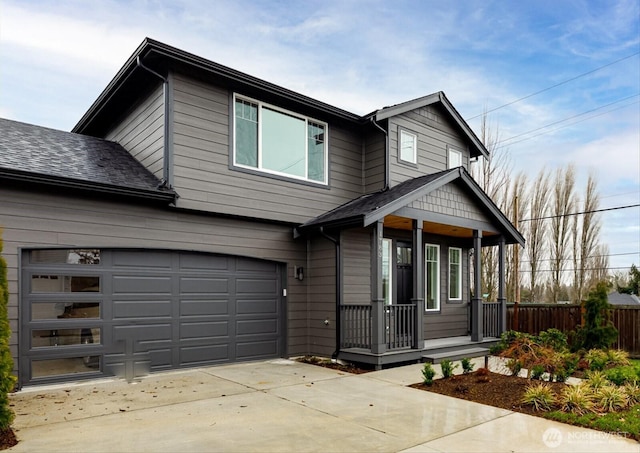 view of front of home featuring a porch, a shingled roof, fence, a garage, and driveway