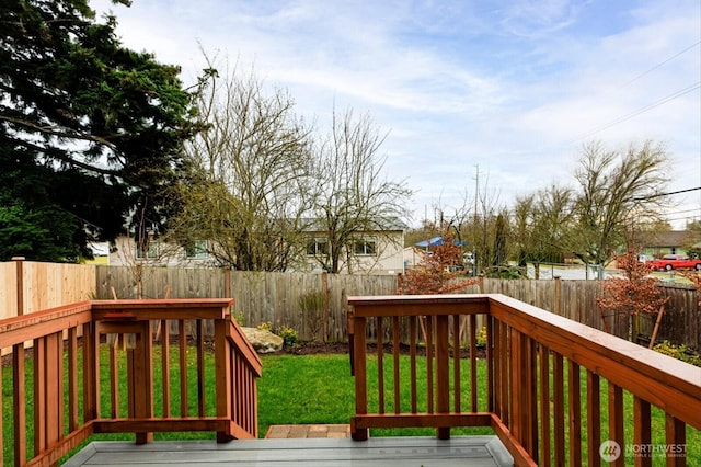 deck featuring a fenced backyard and a yard