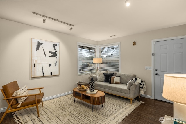 living room with baseboards and wood finished floors