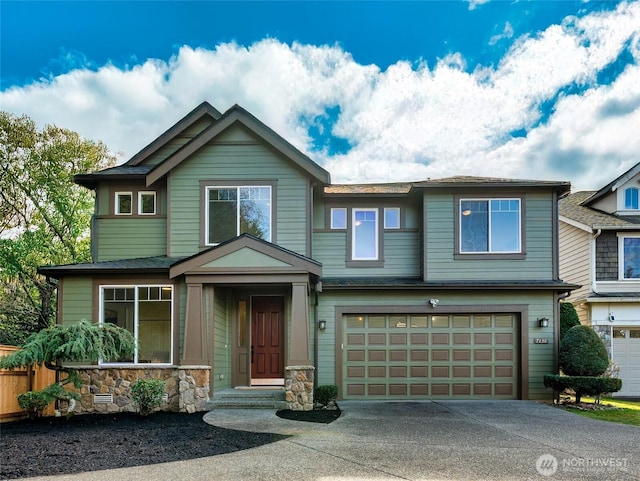 view of front of property with a garage, concrete driveway, and stone siding