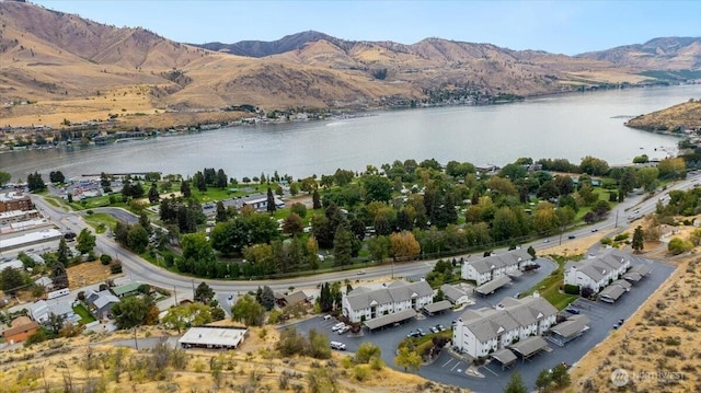 drone / aerial view with a water and mountain view