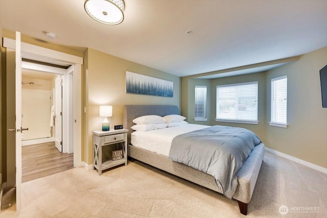 bedroom with carpet floors and baseboards