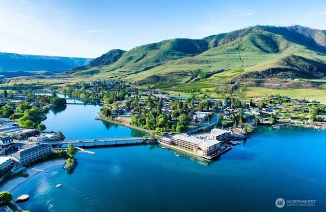 aerial view featuring a water and mountain view