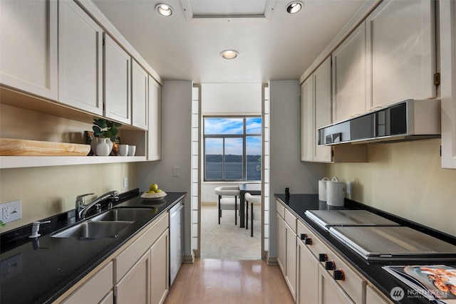 kitchen with open shelves, dark countertops, recessed lighting, a sink, and dishwasher