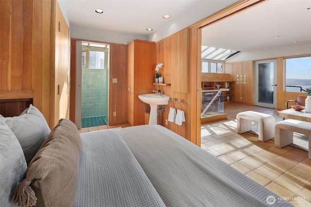 bedroom with recessed lighting, access to outside, a sink, and light tile patterned flooring