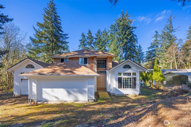 view of front facade featuring driveway and an attached garage