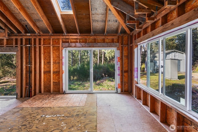 unfurnished sunroom with a skylight