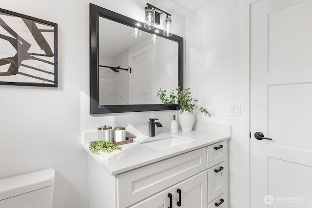 bathroom featuring vanity and toilet