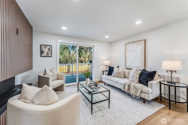 living area with wood finished floors and recessed lighting