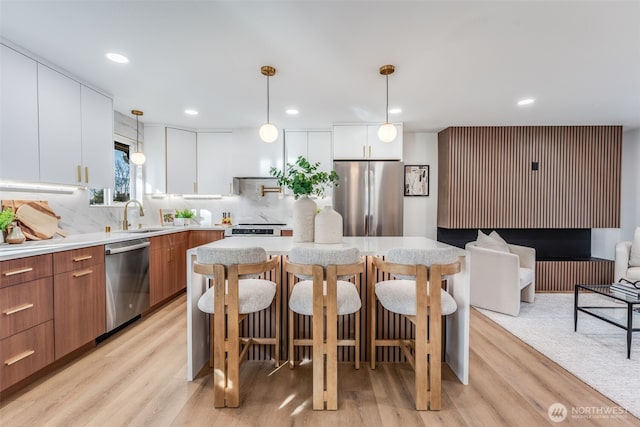 kitchen featuring modern cabinets, appliances with stainless steel finishes, and light countertops