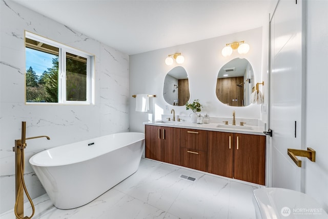 bathroom with double vanity, marble finish floor, visible vents, and a sink